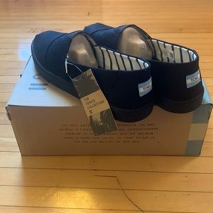 BRAND NEW Size 12 TOMS original slip ons. Black.